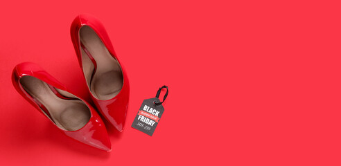 Pair of stylish high heeled shoes and tag with text BLACK FRIDAY SALE on red background