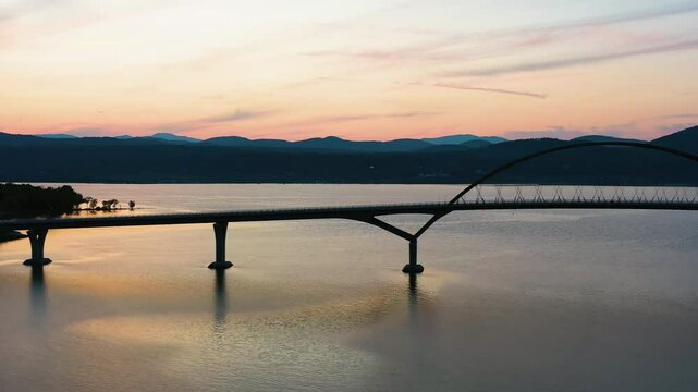 AERIAL: Silhouette Lake Champlain Bridge between New York and Vermont. dusk in USA