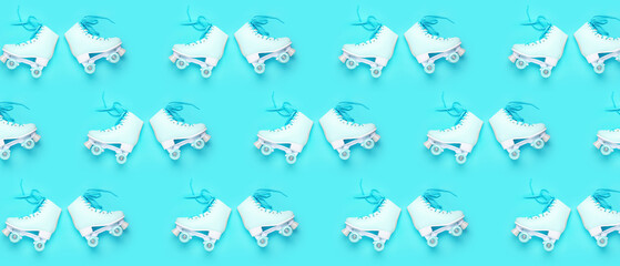Vintage roller skates on color background