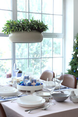 Festive table setting with burning candles and Christmas balls