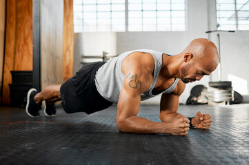 Man, workout or plank with floor at gym for core exercise, abdominal fitness or strength. Active, muscular or male person with intense training or routine for strong abs or muscle gain at health club