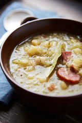 Cabbage soup on wooden background. Close up.