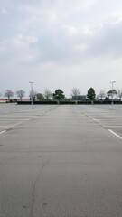 Empty parking lot with scattered empty spaces and no vehicles, urban