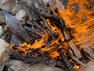 survival experience in nature; boiling water in a plastic bottle and drinking herbal teas