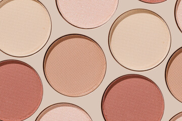 Colorful Swatches eyeshadow refills as minimal geometric pattern. Matte and glitter pans red brown pink shade with sun shadows, detail texture, cosmetic, beauty product, makeup, warm color scheme