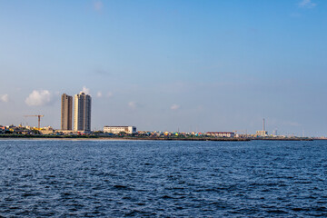 Obraz premium Two tall building view from sea.