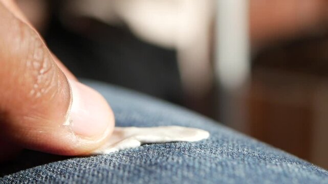 Detailed instructions for effectively removing chewing gum from fabric, with closeup view focus