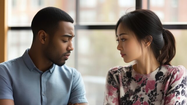 Thoughtful conversation between african american man and asian woman