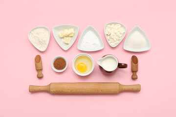 Different ingredients for preparing sweet cinnamon roll on pink background