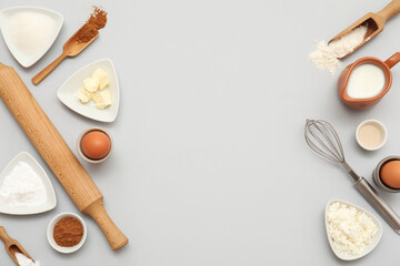 Different ingredients for preparing sweet cinnamon roll on grey background