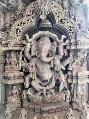 Intricate stone carving of Lord Ganesha in a temple, showcasing detailed craftsmanship