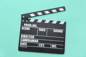 Obraz premium Movie clapper on turquoise background