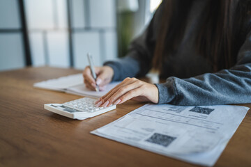 woman sit at desk at home manage household expenses expenditures