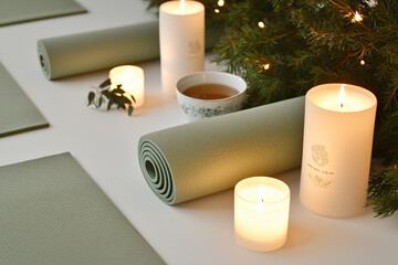 a serene New Year celebration focused on wellness, featuring yoga mats, herbal tea, and candles arranged in a calm, tranquil setting