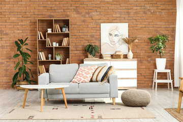 Cozy sofa, coffee table and pouf in interior of living room