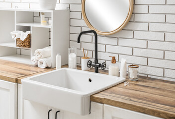 Bath supplies, shelf and sink on table in bathroom