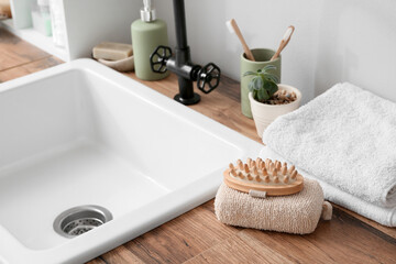 Bath accessories near modern sink in bathroom