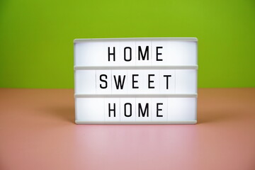 Home Sweet Home letterboard text on LED Lightbox on pink and green background