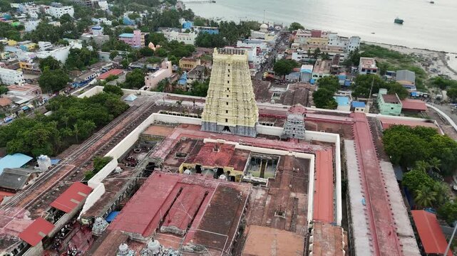 Aerial video of iconic Ramanathaswamy Temple, a magnificent Hindu pilgrimage site, with its towering gopurams and serene atmosphere.network of island and causeways that make up the Pamban Island group