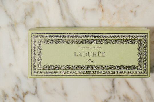 green Laduree Paris macaron box for six macarons on white marble table	