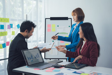 Business Brainstorming: A team of professionals collaborates around a whiteboard covered in colorful sticky notes,  engaged in a lively discussion.  The atmosphere is energetic.