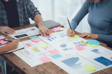 Strategic Collaboration: Team brainstorming session around a table, collaborating on a project...