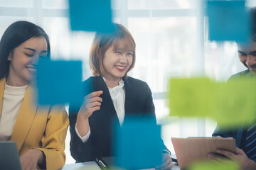 Collaborative Brainstorming: A team of diverse professionals engages in a lively brainstorming session, their creativity and ideas represented by colorful sticky notes.