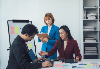 Business Team Brainstorming: A diverse team of professionals collaborates in a modern office setting, brainstorming ideas and strategies, showcasing a dynamic and engaged work environment.  