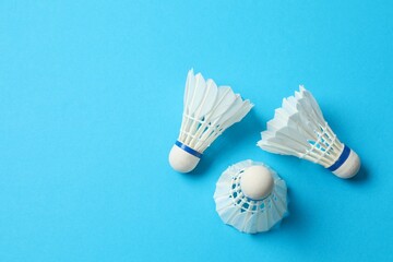 Badminton shuttlecocks on color background 
