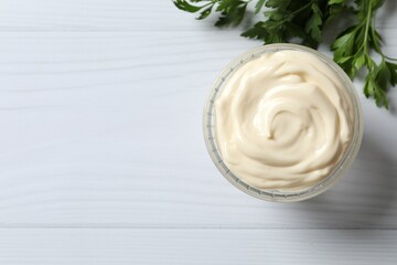 Bowl with mayonnaise on wooden background