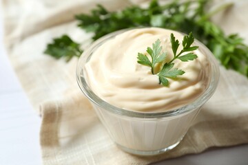 Bowl with mayonnaise on wooden background