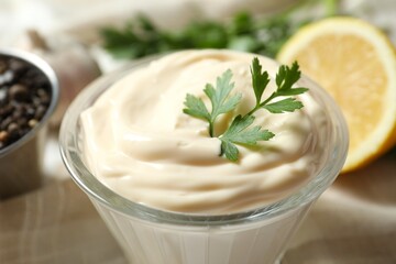 Bowl with mayonnaise and ingredients for cooking on wooden background