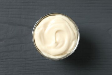 Bowl with mayonnaise on wooden background