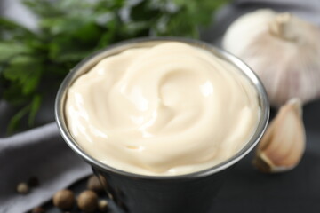 Bowl with mayonnaise on wooden background