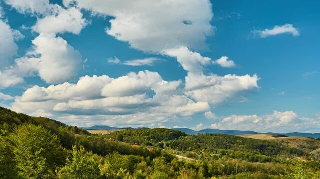 Nature landscape cumulus clouds rolling over hills and mountains time-lapse