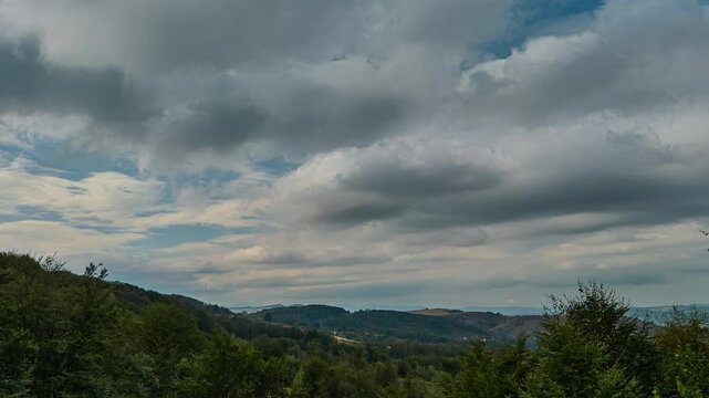 Nature landscape cumulus clouds rolling over hills and mountains time-lapse