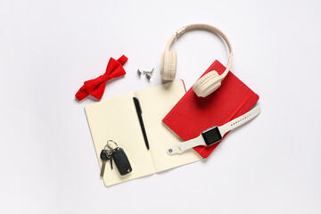 Stylish men's accessories with notebooks and modern headphones on white background