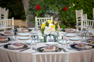 Garden Party Table Setting with Neutral Tones, Glassware, and Vibrant Flowers