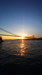 Obraz premium Sunset view over Bosphorus Bridge, Istanbul, perfect for vertical wallpaper.