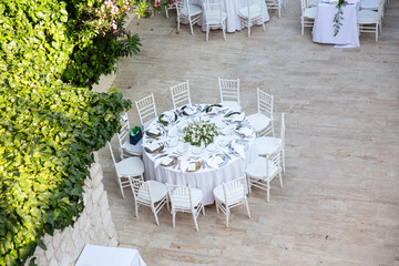 Outdoor Wedding Reception Setup with Elegant Tables and Floral Centerpieces