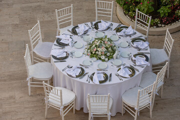 Outdoor Wedding Reception Setup with Elegant Tables and Floral Centerpieces