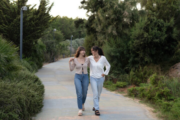 Two girls in a loving couple sharing a tender moment at the park
