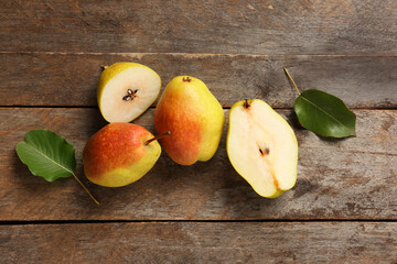 Sweet ripe pears and leaves on wooden background