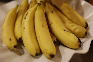 A stunning and vibrant display of fresh yellow bananas is artistically arranged upon a beautiful...