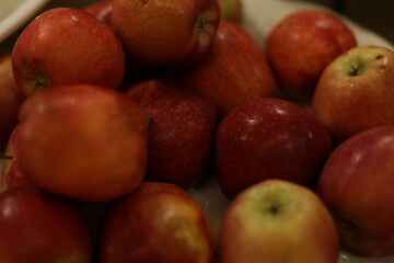 A vibrant collection of fresh, juicy red apples elegantly displayed in a bowl, perfect for satisfying healthy snacking