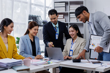 Group of confident business asian people point to graphs and charts to analyze market data, balance sheet, account, net profit to plan new sales strategies to increase production capacity.	