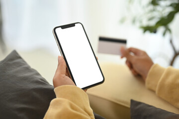 Close up woman making an online purchase with credit card and smartphone