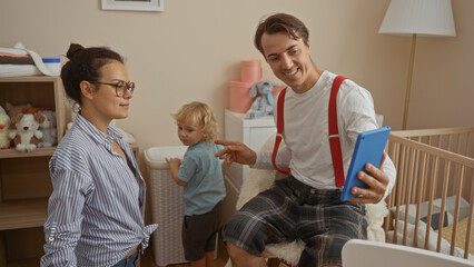 Family enjoying a video call in a cozy living room with mother, father, and son, highlighting love and togetherness in a warm, indoor setting of their home.