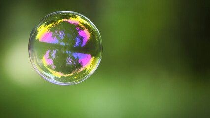 multicolored soap bubble on a green background. Soap bubble. Isolated on green, in spring or summer. reflex, detailed, close-up. multi-colored ball flies. holiday concept, childhood
