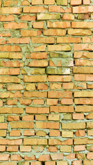 brick wall facade texture texture background. A textured background of decayed old red and white bricks in an exterior uneven wall of a house with dirty whitewashed worn plaster. Brick wall
